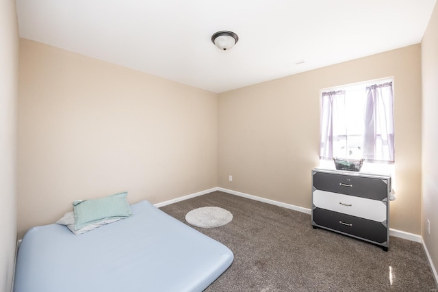 bedroom featuring carpet and baseboards