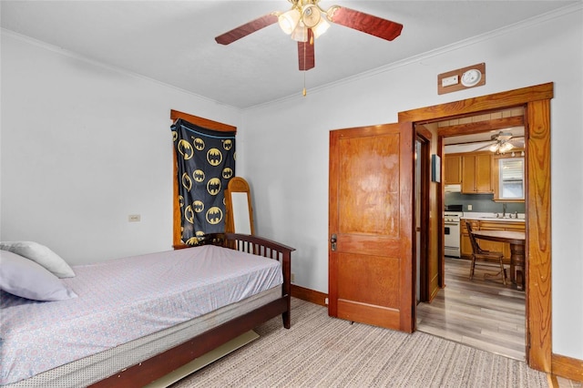 bedroom featuring ornamental molding, sink, light wood-type flooring, and ceiling fan