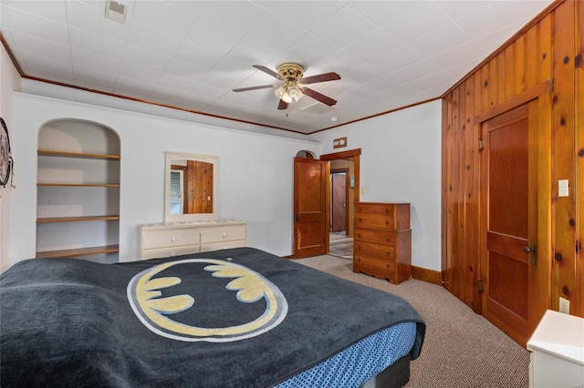 carpeted bedroom featuring ornamental molding and ceiling fan