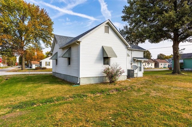 view of side of home featuring a lawn