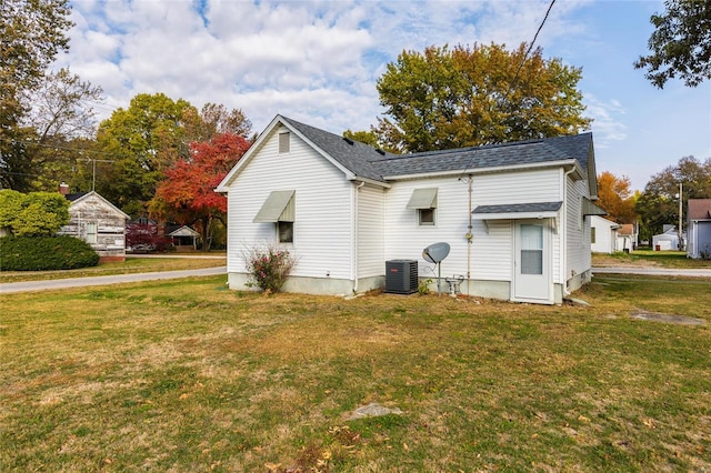 view of home's exterior featuring central AC and a yard