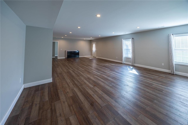 unfurnished living room featuring dark hardwood / wood-style floors