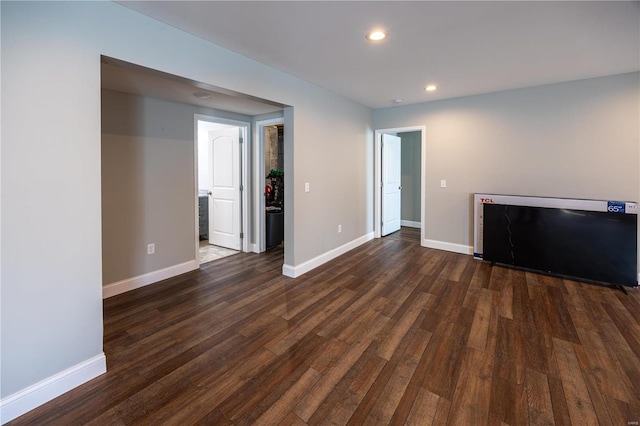 unfurnished living room with dark hardwood / wood-style floors