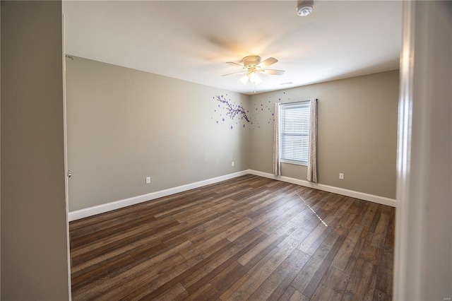 unfurnished room with ceiling fan and dark hardwood / wood-style floors