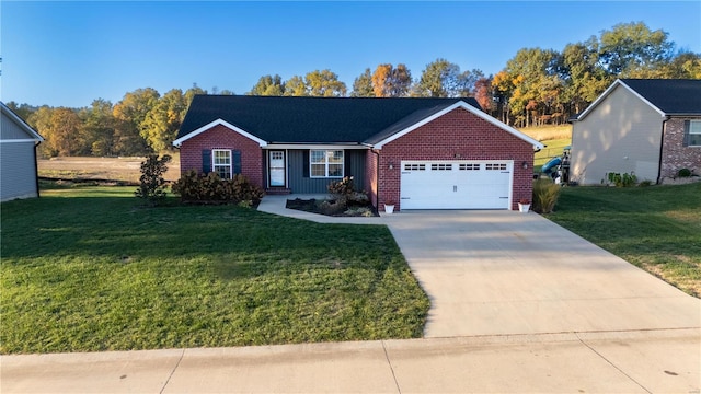 view of front of home with a front yard and a garage