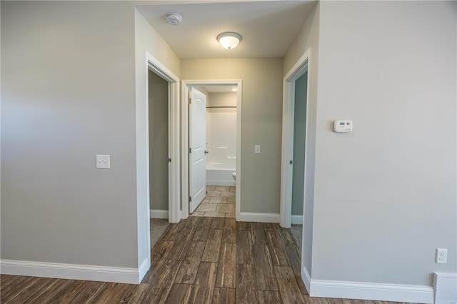 hall with dark hardwood / wood-style floors