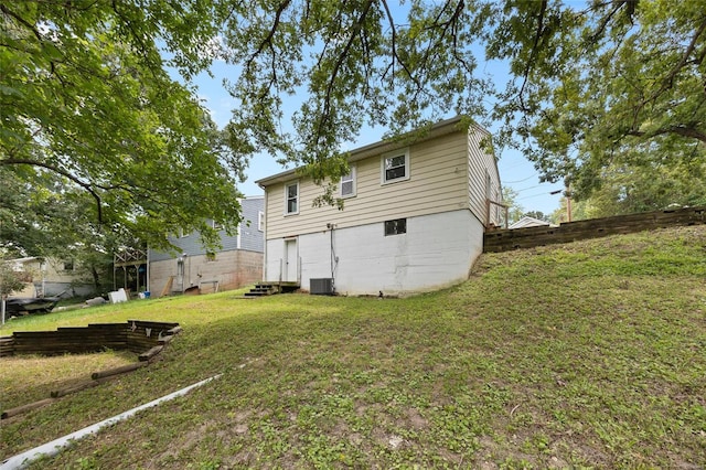 back of house featuring a yard and cooling unit