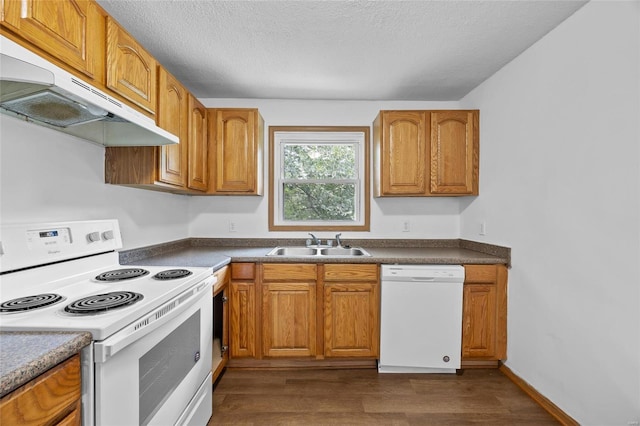 kitchen featuring a textured ceiling, dark hardwood / wood-style floors, white appliances, and sink