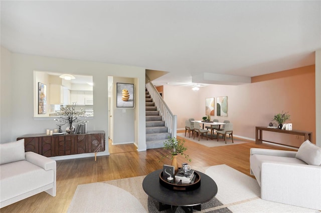 living room featuring hardwood / wood-style floors and ceiling fan