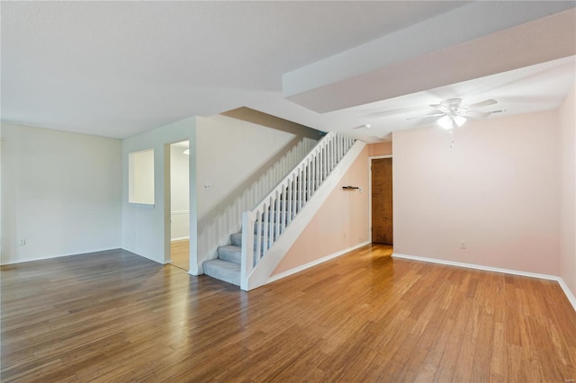 unfurnished living room featuring hardwood / wood-style flooring and ceiling fan