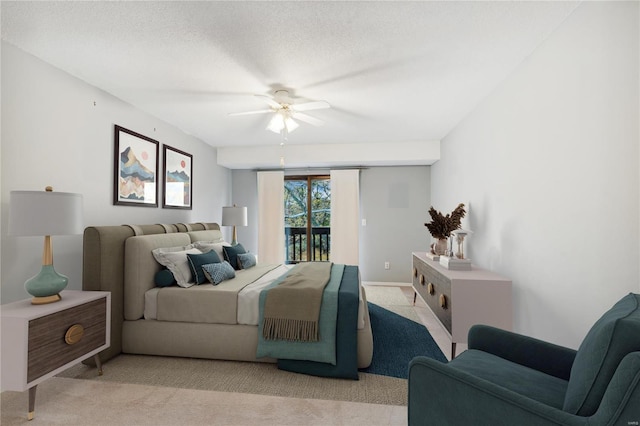 bedroom with a textured ceiling, light carpet, ceiling fan, and access to exterior