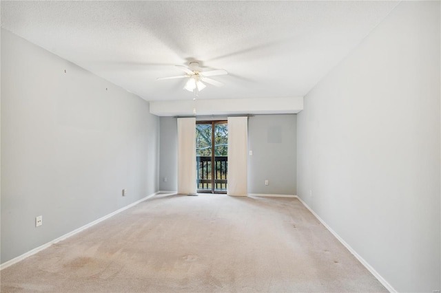 carpeted empty room featuring a textured ceiling and ceiling fan