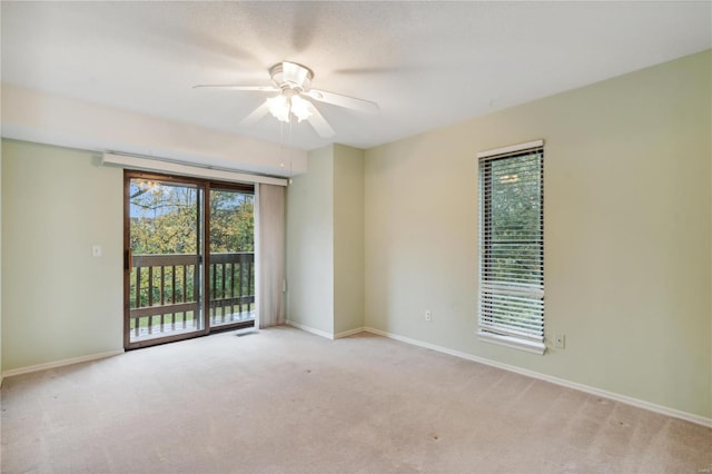 empty room with light colored carpet and ceiling fan