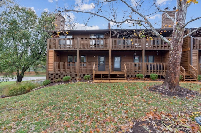 view of front of property featuring a front lawn and a deck