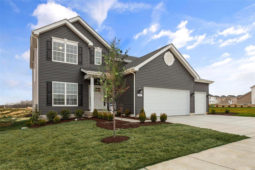 view of front of property with a front lawn and a garage