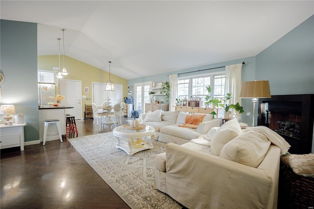 living room with vaulted ceiling and dark hardwood / wood-style flooring