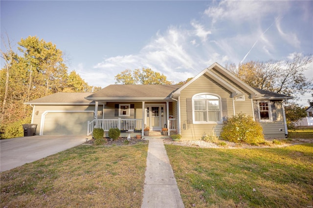 view of front of house featuring a front yard, covered porch, and a garage