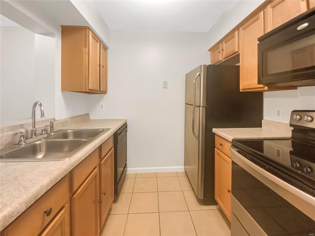 kitchen with light tile patterned flooring, black appliances, and sink