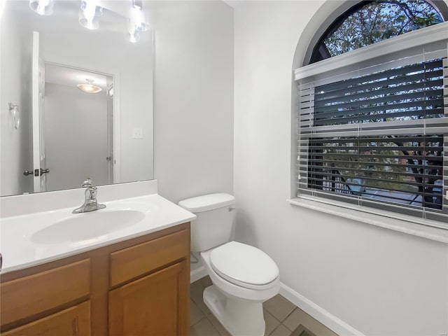 bathroom with vanity, toilet, and tile patterned flooring