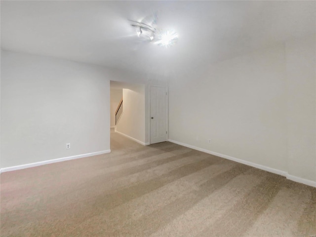 spare room featuring light carpet