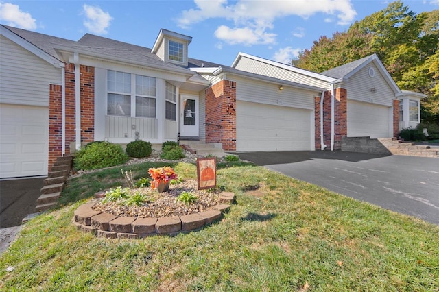 ranch-style home featuring a garage and a front lawn