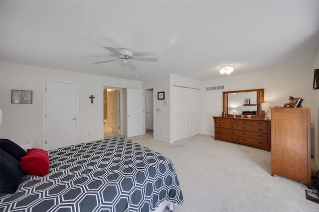 carpeted bedroom featuring a closet and ceiling fan