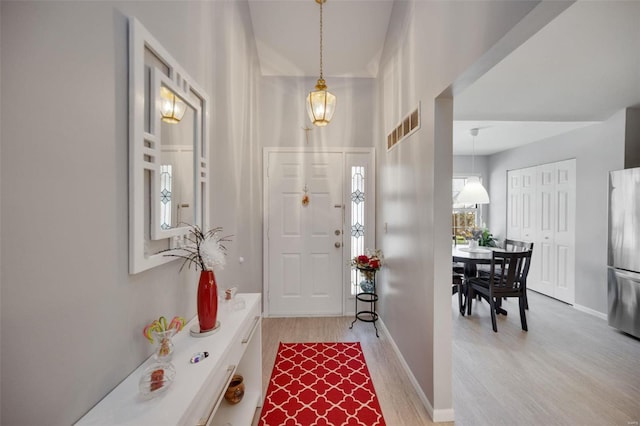 foyer entrance with light hardwood / wood-style floors