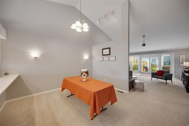 carpeted living room with high vaulted ceiling, ceiling fan with notable chandelier, and rail lighting