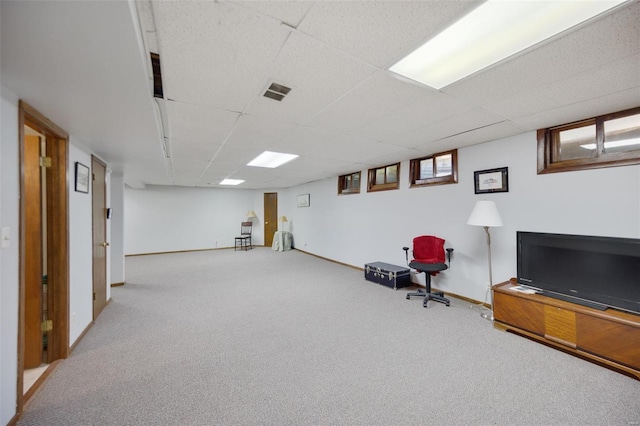 basement with a drop ceiling and carpet flooring