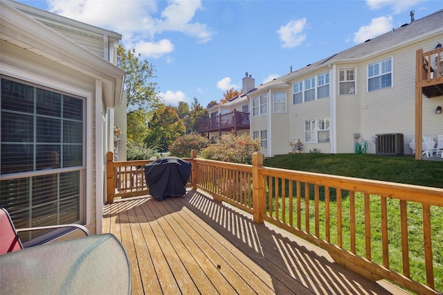 deck with central AC, area for grilling, and a lawn