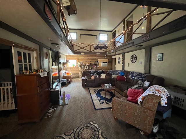 carpeted living room with a high ceiling and a wall unit AC