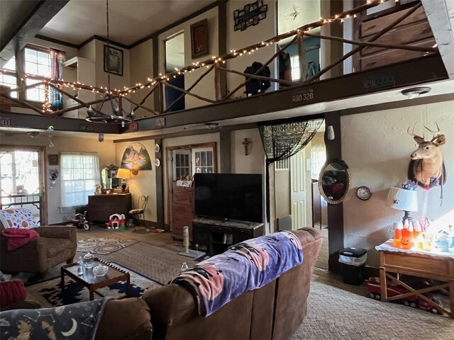 living room featuring carpet, a wealth of natural light, and a chandelier