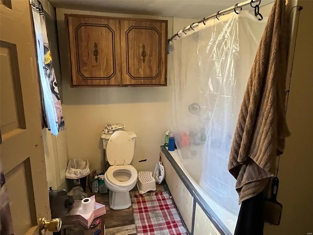 bathroom featuring toilet, shower / tub combo with curtain, and wood-type flooring