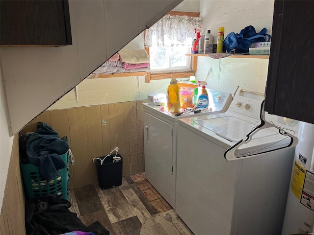 washroom featuring hardwood / wood-style flooring, cabinets, washer and clothes dryer, and wooden walls