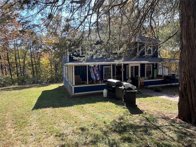 back of house with a lawn