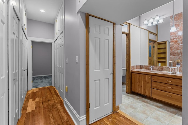 bathroom with wood-type flooring, vanity, and toilet