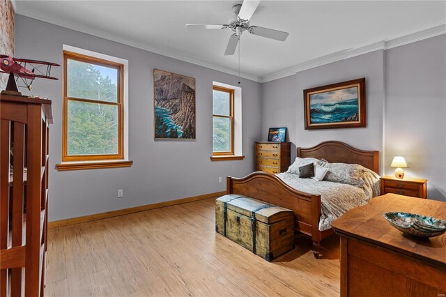 bedroom featuring ceiling fan, light hardwood / wood-style flooring, and crown molding