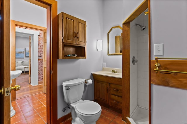 bathroom with tile patterned floors, vanity, toilet, and tiled shower