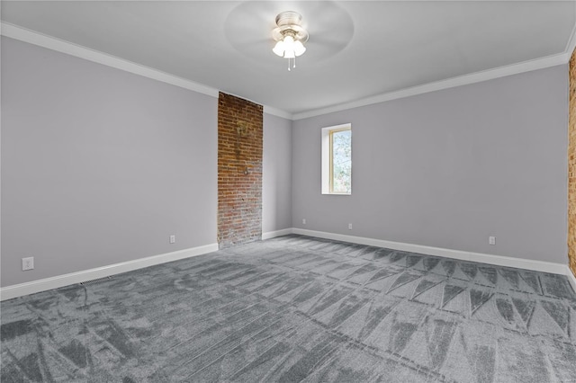 carpeted spare room with ceiling fan and ornamental molding