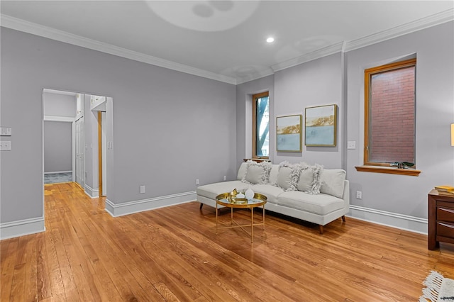 living room with light hardwood / wood-style floors and crown molding