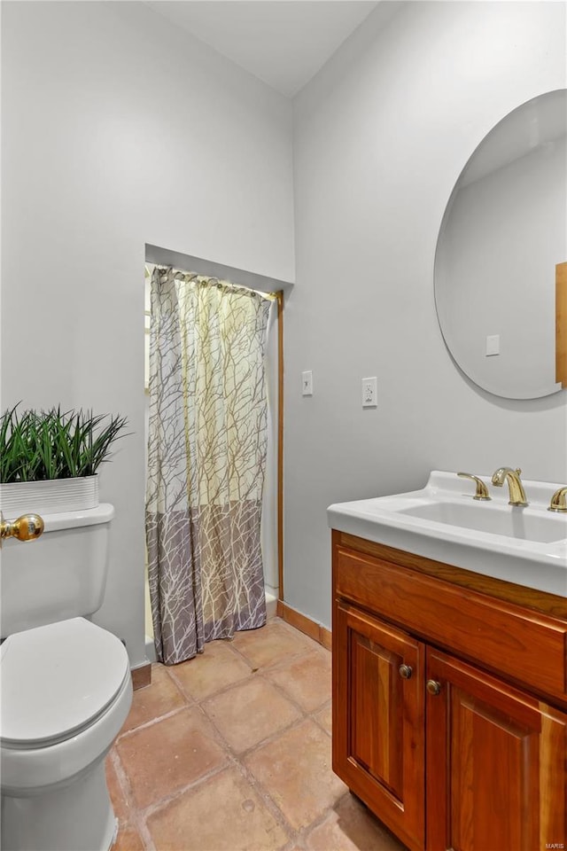 bathroom with vanity, toilet, and walk in shower