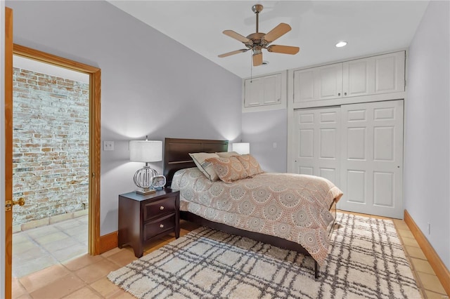 tiled bedroom featuring ceiling fan and a closet