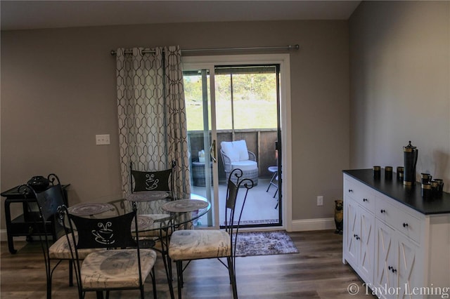 dining area with dark hardwood / wood-style flooring