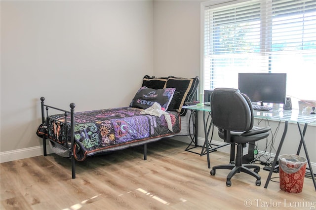 bedroom with hardwood / wood-style floors