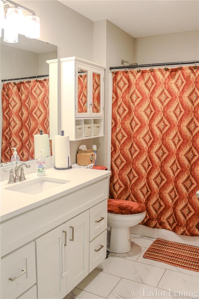 bathroom with vanity, toilet, and curtained shower