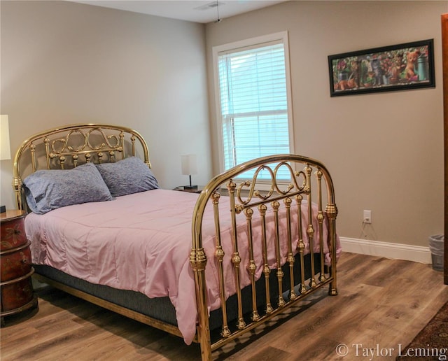 bedroom with hardwood / wood-style floors