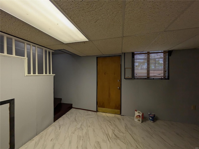 basement featuring a drop ceiling