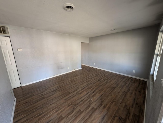 empty room with dark wood-type flooring