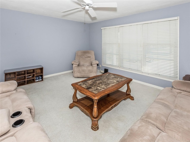 carpeted living room with ceiling fan