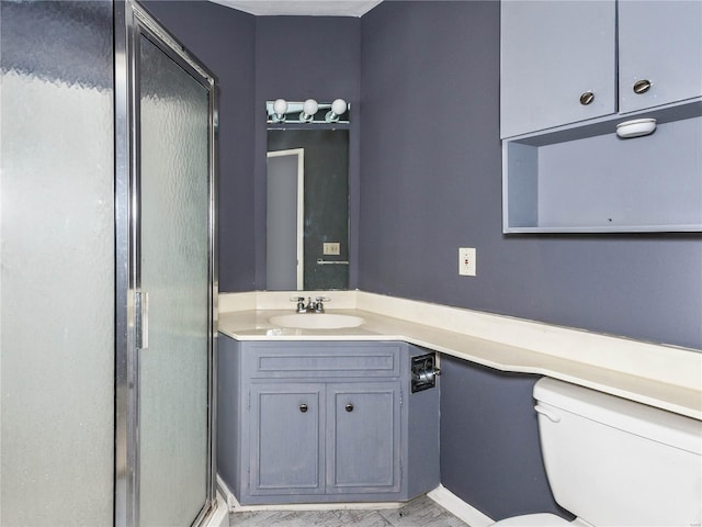 bathroom featuring vanity, toilet, and walk in shower